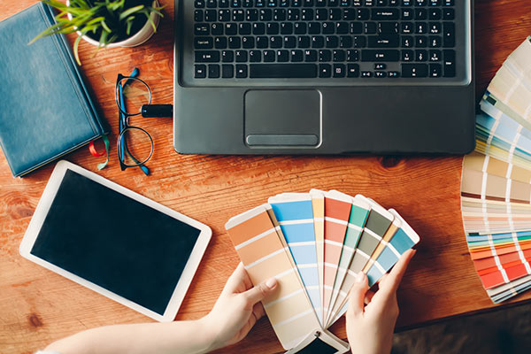 view of a laptop with paint swatches spread around